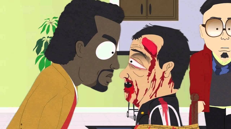 Kanye West staring at Carlos Mencia, who is beaten up