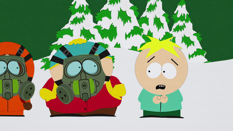 Kenny and Cartman wearing gas masks while Butters looks panicked