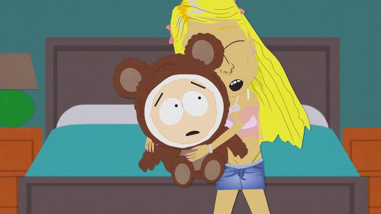 Paris Hilton hugging Butters while seated on bed