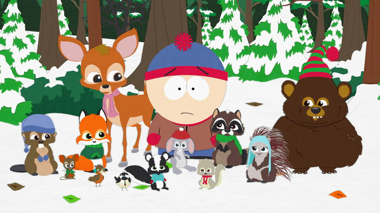Stan standing with the woodland critters outside