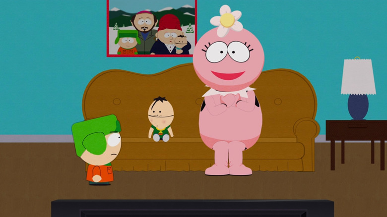 Ike sitting on a couch with Foofa while Kyle looks on disapprovingly on South Park