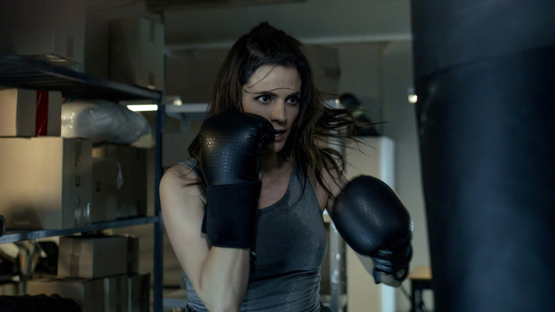Stana Katic's Emily Burke with boxing gloves and a punching bag on Absentia