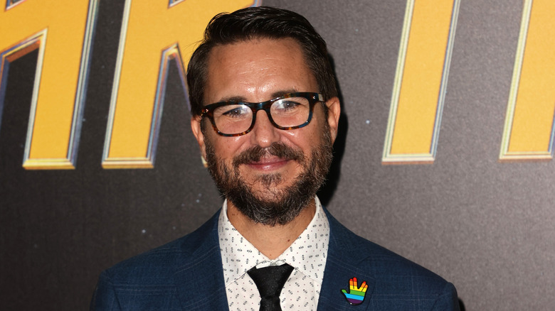 Wil Wheaton smiling for a photo at a Star Trek event