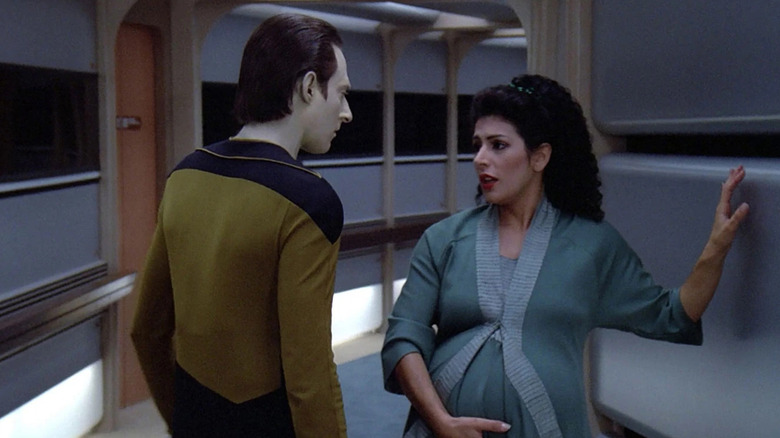 Data (Brent Spiner) speaks to a pregnant Deanna Troi (Marina Sirtis) in a hallway in Star Trek: The Next Generation