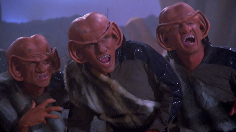 Ferengi warriors snarling at Starfleet Officers