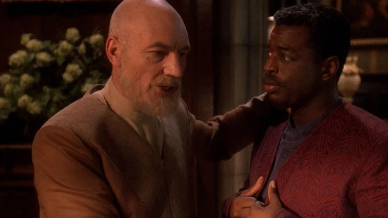 An older Jean-Luc Picard (Patrick Stewart) puts an arm around Geordi La Forge (LeVar Burton) in Star Trek: The Next Generation