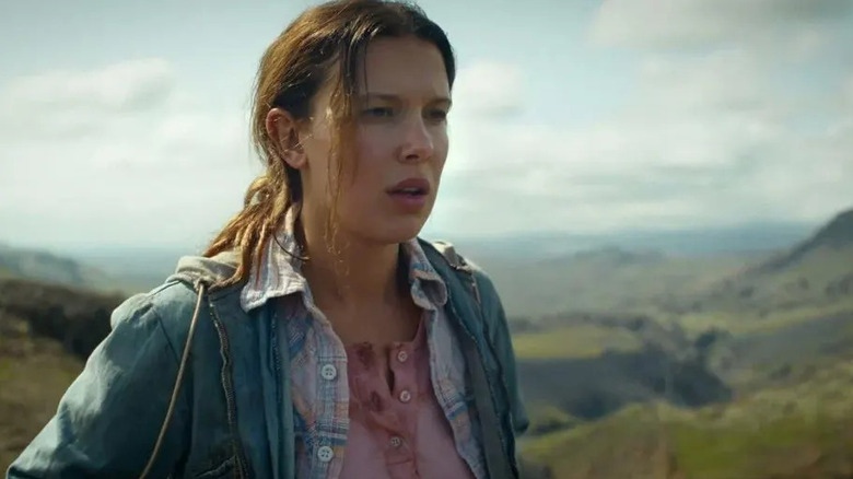 Eleven, her hair grown out, in remote mountains in the Stranger Things finale.