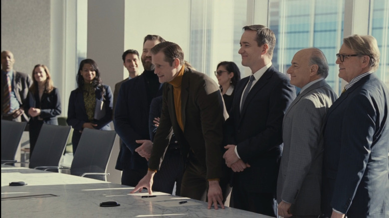 Alexander Skarsgård as Lukas Matsson, standing with Tom, Frank, Karl, and other Waystar executives in front of a contract on Succession