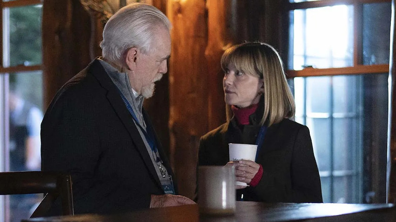 Brian Cox and Holly Hunter as Logan Roy and Rhea Jarrell, speaking in a rustic building on Succession