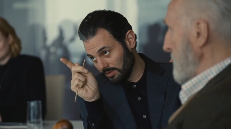 Arian Moayed as Stewy Hosseini, pointing at and voting for Kendall on Succession