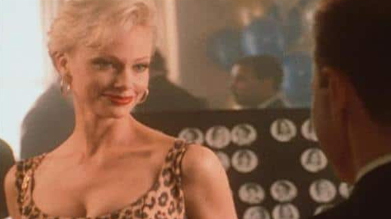 A woman smiles at a high school reunion.