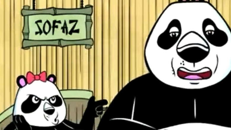 Two pandas argue with each other in a bamboo hut.