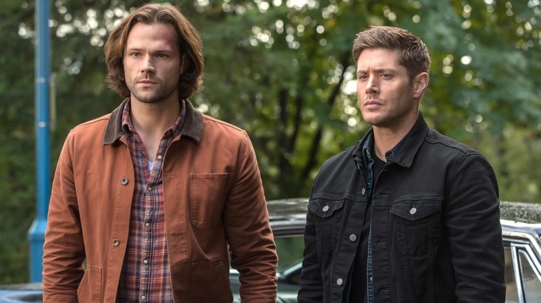 Sam (Jared Padalecki) and Dean (Jensen Ackles) standing next to each other on "Supernatural."