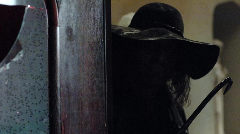 Hook Man (Sean Millington) peeking out from behind a door on "Supernatural."