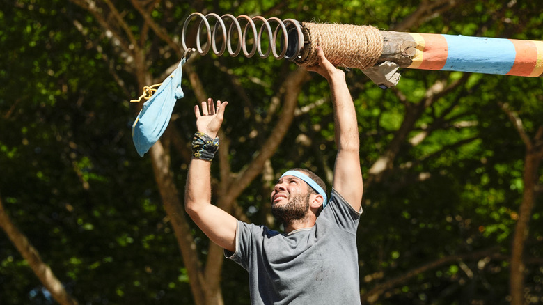 Alex Moore participates in a Survivor challenge