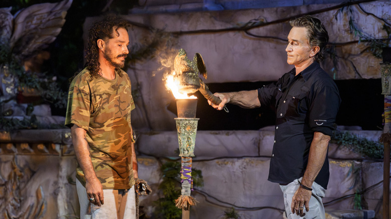 Jeff Probst snuffs Ozzy Lusth's torch