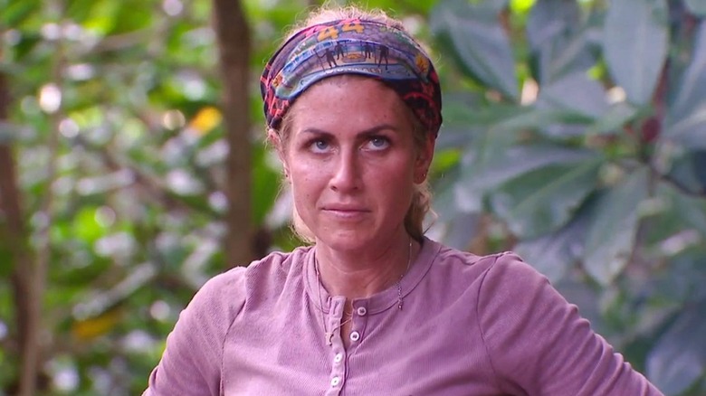 Carolyn with her buff on her head glaring on Survivor