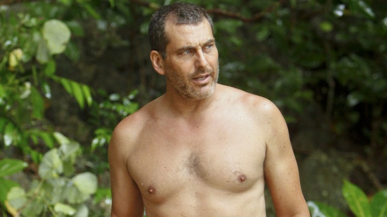 Jonathan Penner looking on shirtless on Survivor