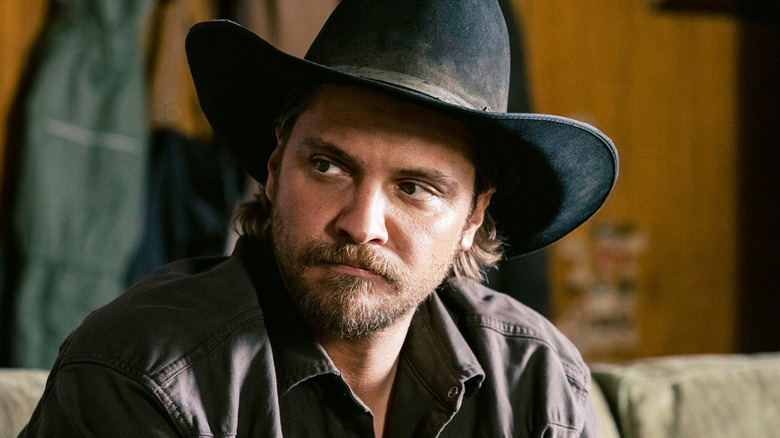 Kayce Dutton (Luke Grimes) sits while glancing to his right in Marshals