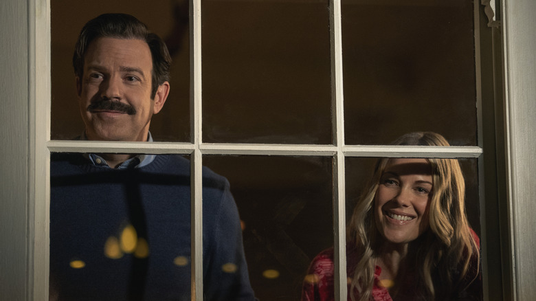 Jason Sudeikis as Ted Lasso and Andrea Anders as Michelle