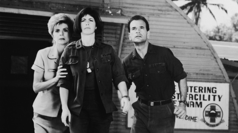 Concetta Tomei as Garreau, Dana Delaney as McMurphy, and Robert Picardo as Dr. Richard watching aid arrive on China Beach