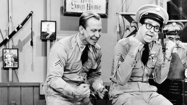 Allan Melvin as Corporal Henshaw and Phil Silvers as Sgt. Bilko celebrate some good news