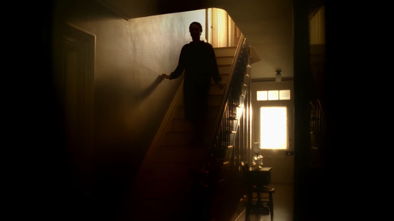 A shadowy, feminine figure walks down the stairs on The Sopranos