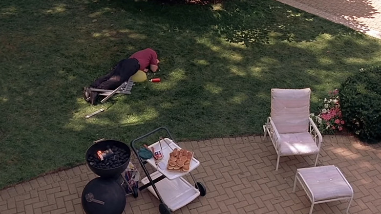 James Gandolfini as Tony Soprano, lying face down in the grass over a broken chair on The Sopranos