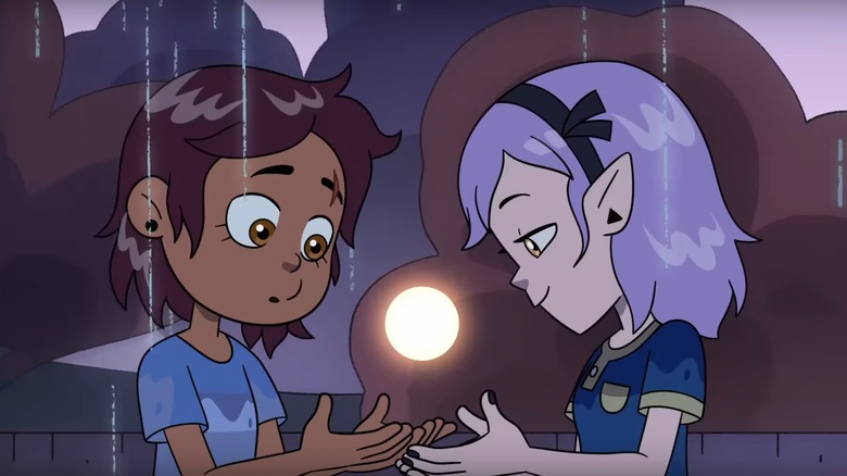 Luz and Amity looking at glowing orb on The Owl House