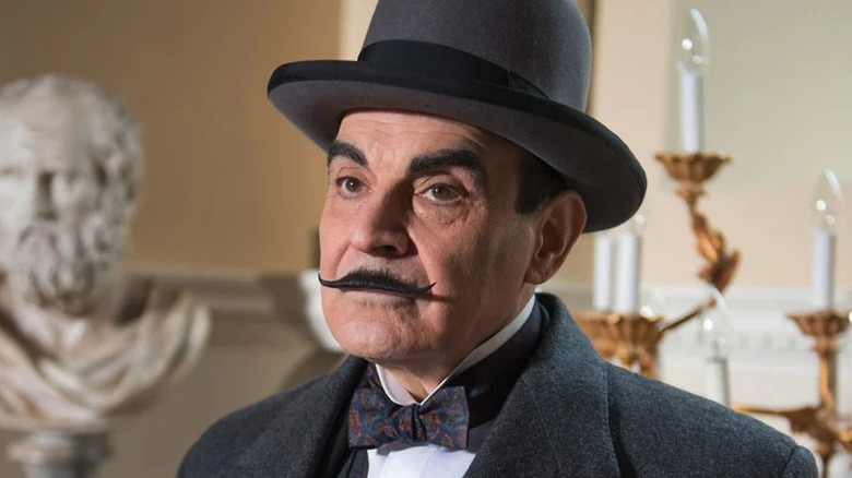 David Suchet's Hercule Poirot wearing a hat and a bow tie on Agatha Christie's Poirot
