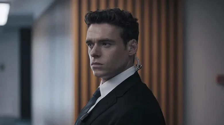 Richard Madden's David Budd wearing a black suit and an earpiece on Bodyguard
