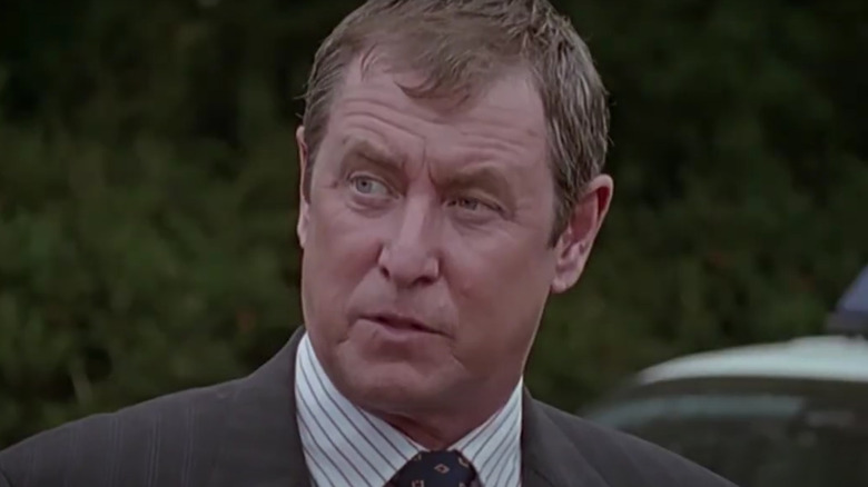 John Nettles' Tom Barnaby looking thoughtful and wearing a suit on Midsomer Murders