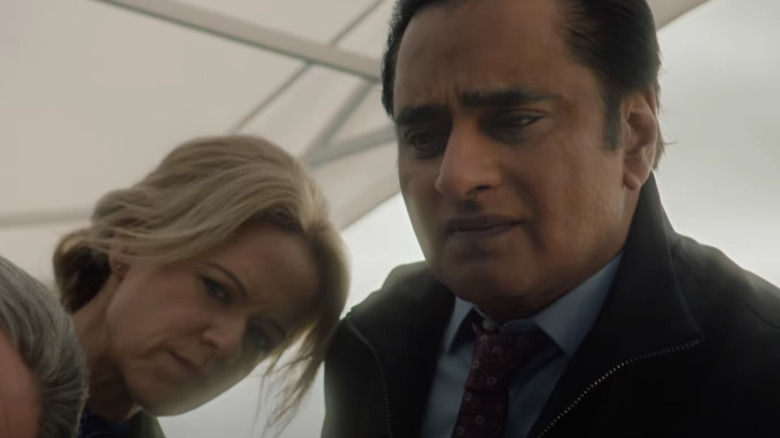 Sinéad Keenan's Jessica James and Sanjeev Bhaskar's Sunny Khan looking concerned inside a white tent on The Unforgotten