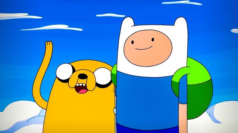 Jake (John DiMaggio) and Finn (Jeremy Shada) stands smiling in the clouds in Adventure Time