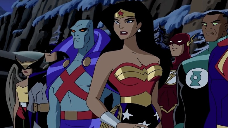 The Justice League stands assembled by a snowy cliffside in Justice League