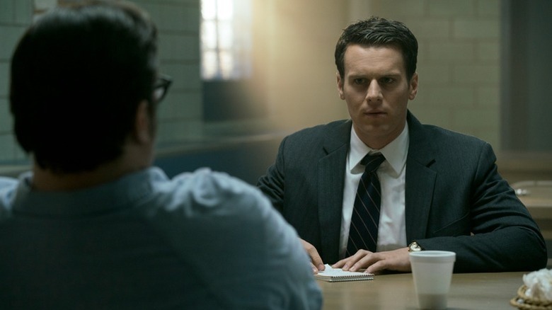 Holden Ford (Jonathan Groff) stares inquisitively at an inmate on Mindhunter