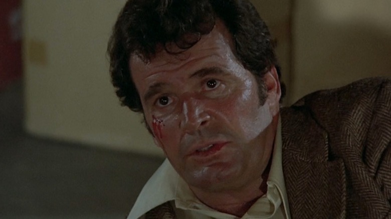 A bleeding Jim Rockford (James Garner) looks up from the floor on The Rockford Files