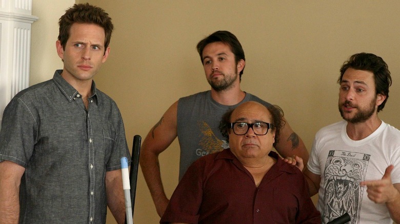 Glenn Howerton, Rob Mac, Danny DeVito, and Charlie Day as Dennis, Mac, Frank, and Charlie posing on Always Sunny