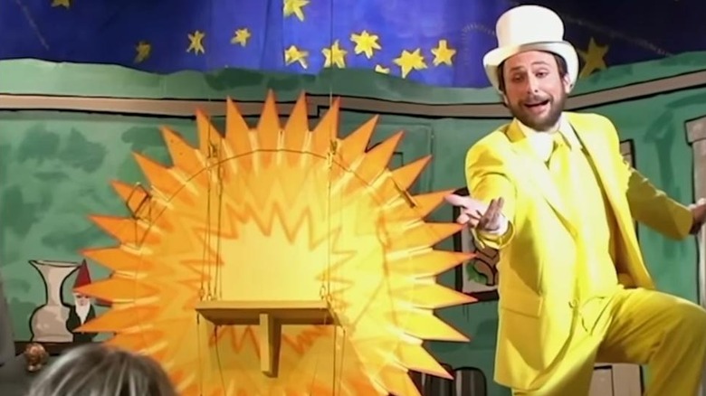 Charlie Day as Charlie dressed as the Dayman proposing to the waitress on stage on Always Sunny