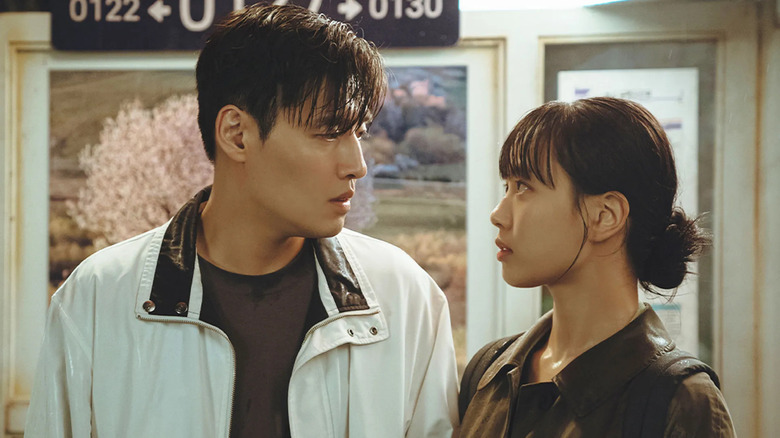 A wet Han Beom-woo (Kang Ha-neul) and Mo Yeon-joo (Go Min-si) stare deeply at each other on Tastefully Yours