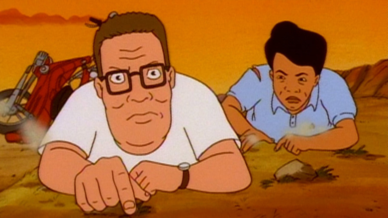 Hank and Kahn crawling in the dirt on King of the Hill
