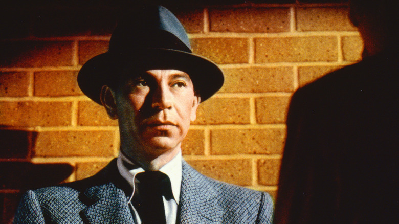 Sgt. Joe Friday looking on against a brick wall