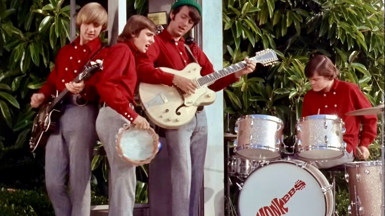 Peter Tork, Davy Jones, Mike Nesmith, and Micky Dolenz performing outside