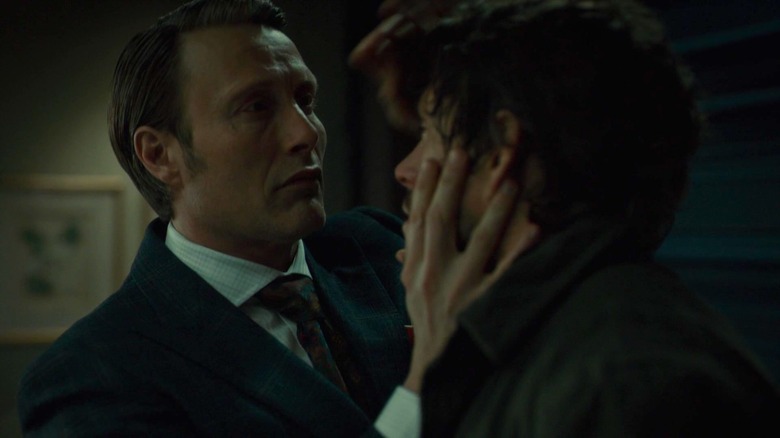 Mads Mikkelsen as Hannibal grabbing the face of Hugh Dancy as Will on Hannibal