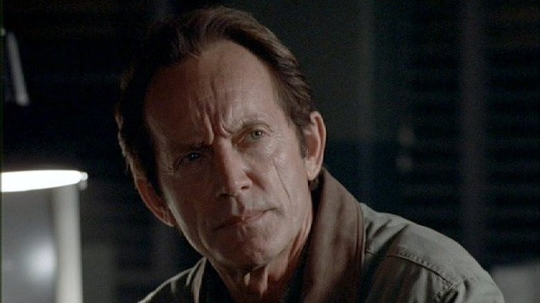 Lance Henriksen looking serious as Frank Black on Millennium