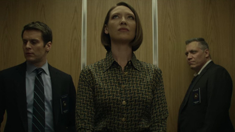 Jonathan Groff as Holden Ford, Anna Torv as Wendy Carr, and Holt McCallany as Bill Tench standing in elevator on Mindhunter