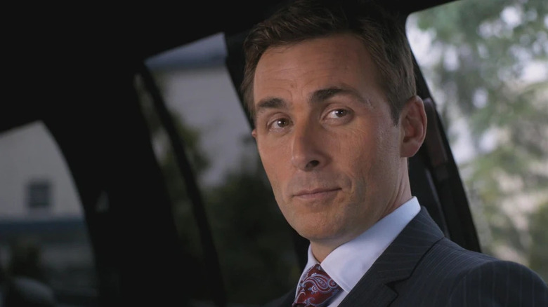 James Patrick Stuart's Dick Roman sitting in a limo on Supernatural