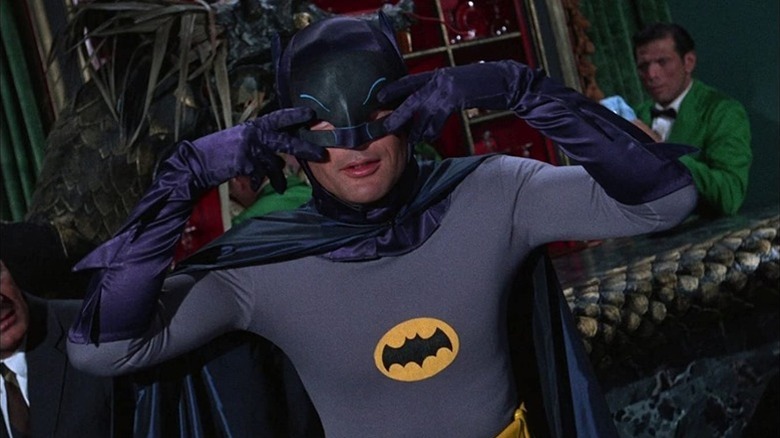 Batman (Adam West) dances with his fingers by his eyes in Batman