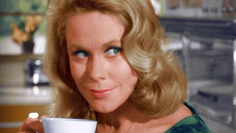 Samantha Stephens (Elizabeth Montgomery) looks up smirking while holding a teacup in Bewitched