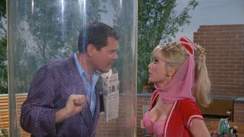 Tony Nelson (Larry Hagman) speaks with Jeannie (Barbara Eden) while trapped in a glass tube in I Dream of Jeannie
